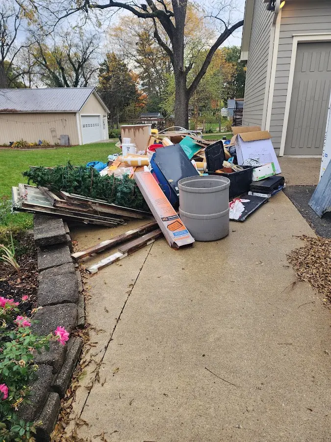 Dumpster being loaded with debris for 12 Yard Dumpster Rental in Knoxville